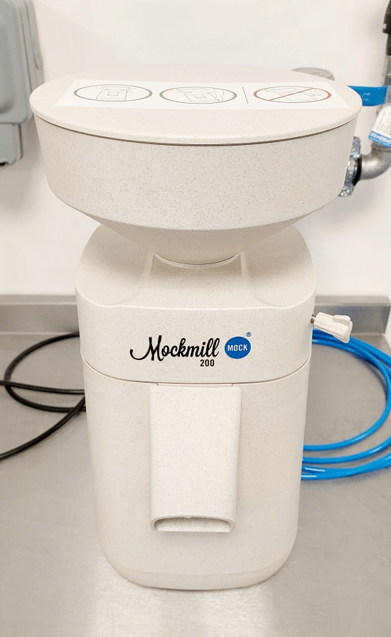 Mockmill grain mill with adjustable settings and corundum-ceramic grinding stones.
