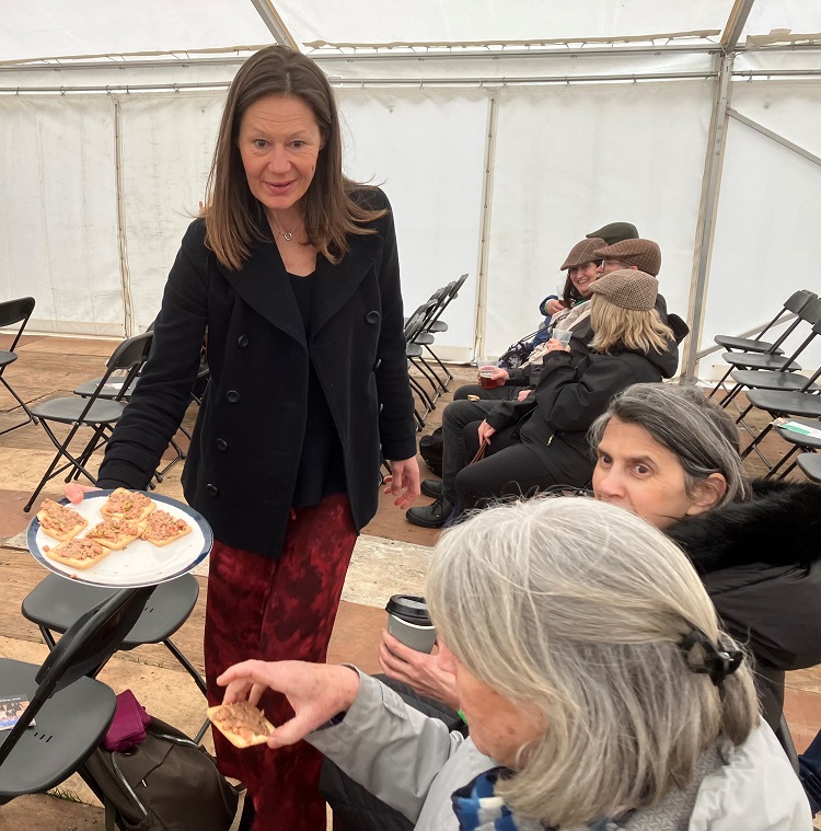 Valerie handing out samples of 'Chuna' on crackers for the audience to taste and comment on