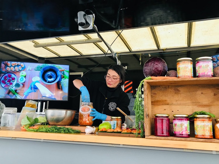 Zambur Ferments teaching the audience how to make kimchi