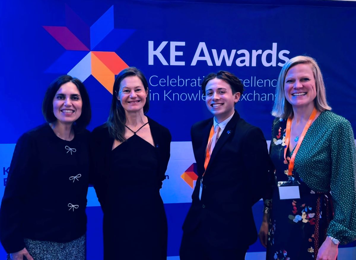 Four people standing in front of a KE Awards banner with the text 'Celebrating Excellence in Knowledge Exchange.' Valerie Pondaven, a finalist from the Natural Resources Institute (NRI), is among the group, all dressed formally.