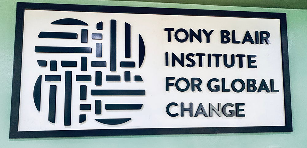 Tony Blair Institute for global change, black and white sign on a green wall 